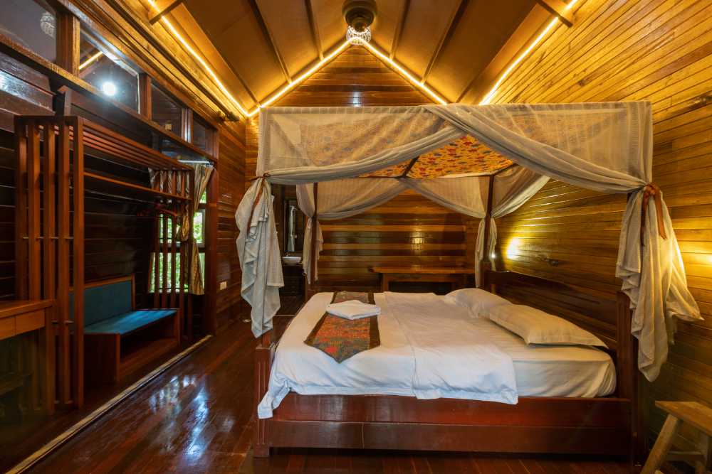 King chalet room with a canopy bed and mosquito net