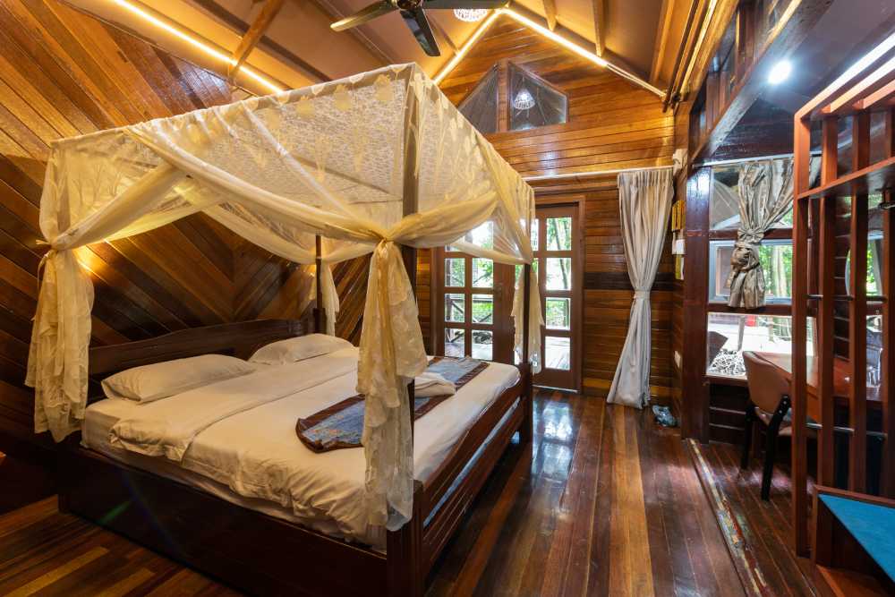 Chalet room with a canopy bed under a mosquito net